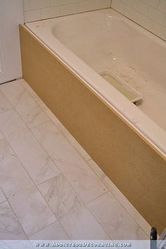 a bath tub sitting next to a toilet in a bathroom