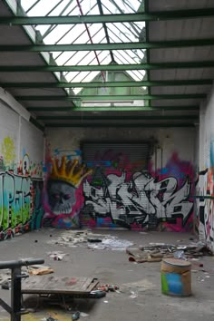 an empty room with graffiti on the walls and floor, in front of a metal roof