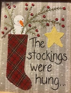 a christmas stocking with a snowman in it and the words, the stockings were hung