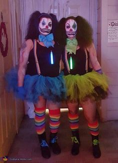 two women dressed up as clowns standing next to each other in front of a door