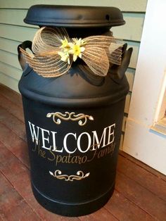 a large black trash can with a bow on it's lid that says welcome to the spaaro family