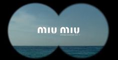 an image of the ocean seen through two heart shaped windows with words written on them