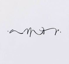 the word mom written in cursive writing on a white paper with black ink