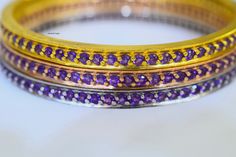 Metal: 14kt Yellow, White And Rose Gold Weight Of Bangle Including Gems: 31 grams Stone: Amethyst Stone Shape: Round Amethyst Weight: 4.86 ctw Closer Type: Slip On Width Of Bangle: 4.800mm Inside Circumference Of Bangle: Approximately 2 1/2 inches fits a 7 1/2 wrist. If you need a different size please inquire. Customizable: Yes, we can make these bangles in any color metal with any gems. Variations Listed: Pink Sapphire- https://www.etsy.com/listing/662539224/14k-rose-gold-pink-sapphire-bangle? Purple Gemstone Bangle For Formal Occasions, Adjustable Amethyst Bangle Jewelry, Formal Purple Gemstone Bangle, Luxury Amethyst Bangle Bracelet, Adjustable Amethyst Bangle, Purple Amethyst Bangle, Multicolor Multi-stone Bangle, Sapphire Bangle, Amethyst Bangle