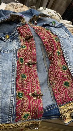 an old jean jacket with some gold buttons on it