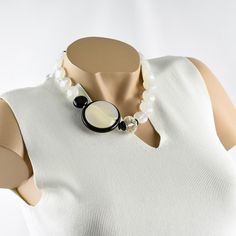 This is part of Chairish’s Costume Jewelry assortment.  This elegant Angela Caputi, made in Italy resin choker beaded necklace works on black and white contrast. The necklace features assorted beads and a side medallion. It is built with white opalescent round beads, a single black bead, and a large crystal clear faceted bead ornate with a clear rhinestones spacer ring. The pendant features a stylized Yin-Yang carved symbol with black resin framing and white pearlized resin. Her matching of colo Resin Choker, Black And White Contrast, Ring Spacer, Large Crystal, Black Resin, Large Crystals, Clear Rhinestones, Faceted Bead, Yin Yang