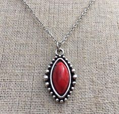 Simple, chic and versatile!  Here is a red stone necklace that is set in a perfectly detailed silver frame.  The perfect everyday necklace! Made from allergy free plated silver.  The pendant measures 1” long by 1/2” wide.  It hangs from a shiny strong 18” stainless steel necklace chain with a lobster clasp.I have matching earrings in my shop if you would like the whole set.  Here is the link............. https://etsy.me/2R5NsWx I have this same style pendant necklace available in other color way Red Bohemian Nickel-free Necklace, Bohemian Red Nickel-free Necklace, Red Southwestern Sterling Silver Necklace, Red Jewelry With Large Oval Pendant, Southwestern Red Gemstone Jewelry, Southwestern Style Red Gemstone Jewelry, Red Southwestern Style Jewelry Gift, Southwestern Style Red Jewelry For Gifts, Southwestern Style Red Jewelry For Gift