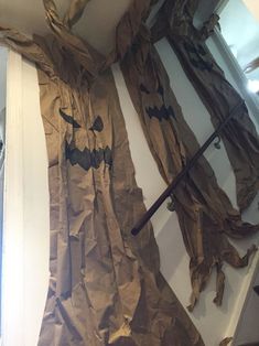 an image of a halloween scene made out of brown paper with bats and pumpkins on it