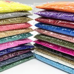 there are many different colors of sequins in the bag on the table together