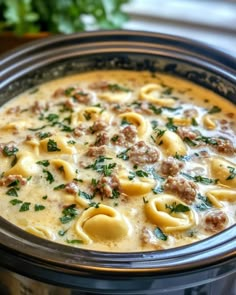 a crock pot filled with pasta and meat