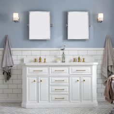 a bathroom with two sinks and mirrors on the wall