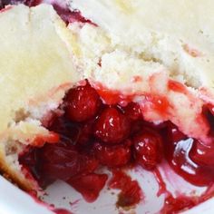 a cranberry cobbler is cut in half and ready to be eaten