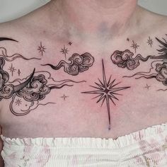 a woman's chest with stars and clouds on it