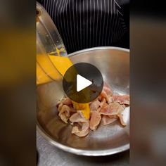 a person pouring mustard into a pan filled with bacon and hams on a table