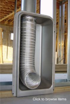 a large metal object sitting in the middle of a room with wooden framing around it