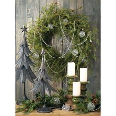 a christmas wreath and candles on a table