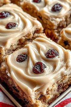 a close up of some food on a pan with white frosting and cranberries