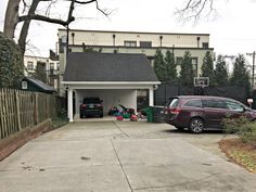 a car parked in front of a house with a basketball hoop on it's roof