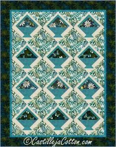 a blue and white quilt with green leaves on the border, in front of a black background