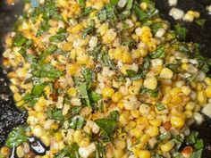 corn and spinach stir fry in a wok