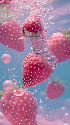 some strawberries are floating in the water with bubbles on their backs and bottom half