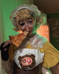 a woman in costume eating a slice of pizza