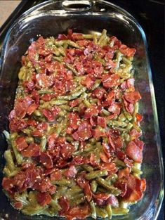 a casserole dish filled with green beans, bacon and other toppings on top