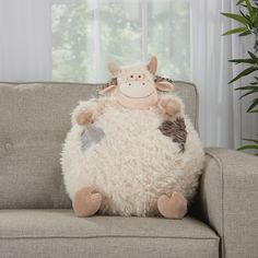 a stuffed animal sitting on top of a couch