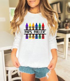 Customized Name Teacher Crayon Sweatshirt, Custom Kindergarten Teacher Sweatshirt, Personalized Back to School Sweatshirt, Gift For Teacher, Custom Name Teacher,Customized Crayon,Teacher Sweatshirt,Custom Kindergarten,Kindergarten Teacher,Personalized Teacher,Back School Hoodie,Gift For Teacher,Elementary Teacher,School Sweatshirt,Teacher Lİfe Hoodie,Customized Teacher,Teacher Appreciation  Welcome to my store! I'm absolutely thrilled to have you here. My main aim is to ensure your happiness and White Crew Neck Sweater For School, Multicolor Long Sleeve Pre-shrunk Shirt, School Long Sleeve T-shirt With Name Print, Multicolor Long Sleeve Shirt With Letter Print, White Long Sleeve Sweater With Name Print, White Long Sleeve Top With Name Print, Multicolor Crew Neck Tops For School, Multicolor Fall Tops For School, Multicolor Tops For School In Fall