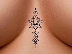 the back of a woman's breast with a lotus tattoo on it