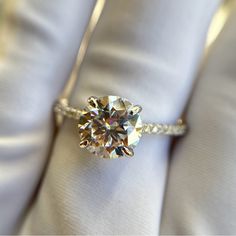 a diamond ring sitting on top of a white cloth