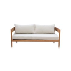 a white couch with two pillows on it's back and the seat upholstered