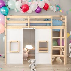 a child's room decorated with balloons and toys