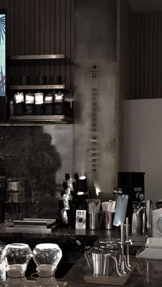 a kitchen counter topped with lots of pots and pans next to a tv screen