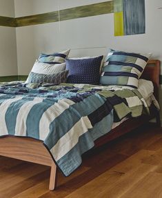 a bed sitting on top of a hard wood floor