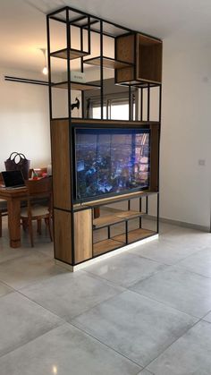 an entertainment center in the middle of a room with a television on it's stand