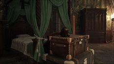 a bedroom with a bed, dresser and chest in it's center surrounded by green drapes