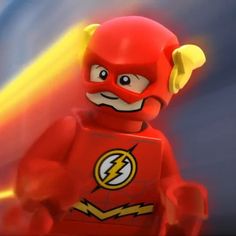 the flash lego figure is shown in front of a blurry background with light coming from behind it