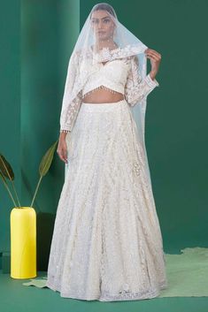 Indulge in the regal charm of our Bridal Lehenga BL-336. The cosmic latte color and tonal pearl and sequin work elevate its elegance, while the back shear blouse adds a touch of modernity. Perfect for a summer nikah ceremony, this lehenga exudes luxury and sophistication.