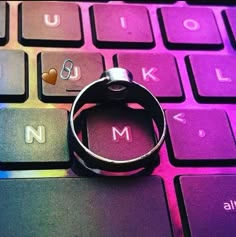 a ring sitting on top of a computer keyboard