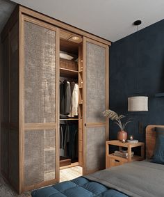 a bedroom with blue walls and an armoire in the corner, next to a bed