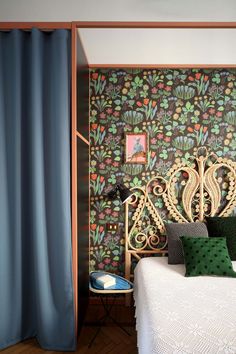 a bedroom with green and blue wallpaper on the walls