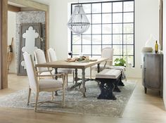 a dining room table with chairs and a rug