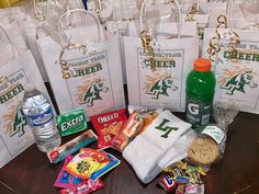 several bags with snacks and drinks are on a table