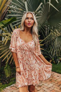 - You will be seaside sippin in style in this vibrant shift dress! - Lightweight material with a paisley print - Scoop neckline with back gathered detail - Loose, half sleeves - Ruffle under-bust detail - Relaxed silhouette that ends in an uneven mid-thigh length hemline with ruffle detail Measurements S : Bust 38", Hip 38", Length 30", Sleeve Length 12.5", Waist 34". M : Bust 40", Hip 40", Length 31", Sleeve Length 12.5", Waist 36". L : Bust 42", Hip 42", Length 31.5", Sleeve Length 13", Waist 38". Short Sleeve Paisley Print Vacation Dresses, Short Sleeve Paisley Print Dresses For Vacation, Short Sleeve Dresses With Paisley Print For Vacation, Paisley Print Short Sleeve Beach Dress, Beach Dresses With Paisley Print And Short Sleeves, Short Sleeve Summer Dress With Paisley Print, Paisley Print, Scoop Neckline, Half Sleeves