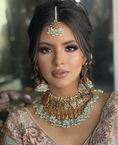 a woman wearing an elaborate necklace and earrings