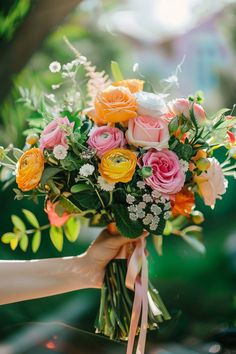 a woman holding a bouquet of flowers in her hand