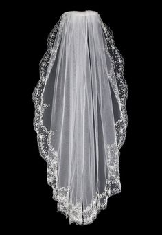 a white veil with lace on the top and bottom is shown against a black background