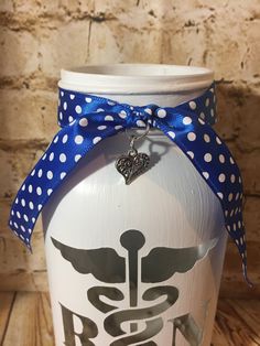 a white jar with a blue ribbon around it