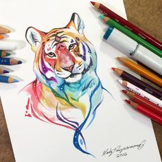 a drawing of a tiger with colored pencils next to it